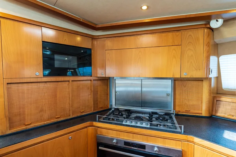 Orion Yacht Photos Pics Luxurious Catana 90 yacht kitchen with wood cabinetry and modern appliances, 2008 model.