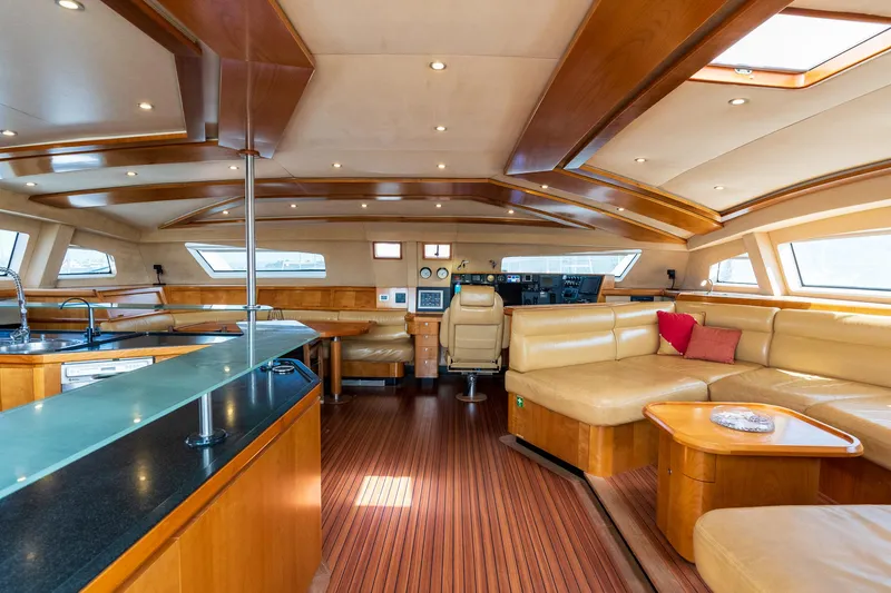 Orion Yacht Photos Pics Luxurious interior of 2008 Catana 90 yacht with elegant wood finishes and spacious seating.