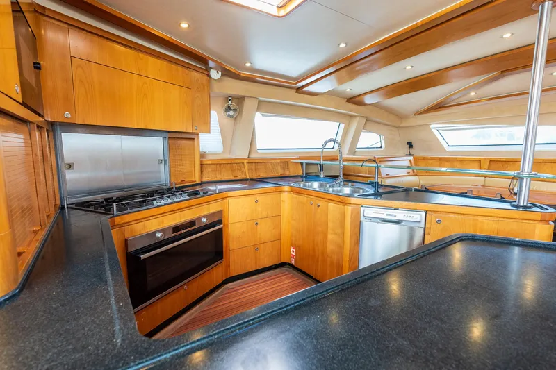 Orion Yacht Photos Pics Luxurious Catana 90 yacht kitchen interior with modern appliances and wooden cabinetry, 2008 model.