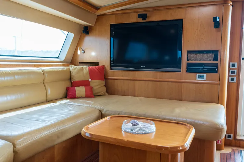 Orion Yacht Photos Pics Luxurious Catana 90 yacht interior with leather seating, TV, and wooden accents, 2008 model.