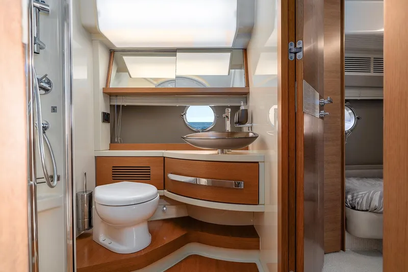 Elena I Yacht Photos Pics Luxurious bathroom interior of 2013 Azimut 64 yacht with modern fixtures and wooden accents.