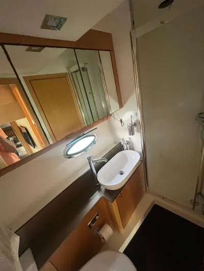  Yacht Photos Pics Bathroom interior of 2011 Sunseeker Portofino 48 yacht, featuring sink and shower.