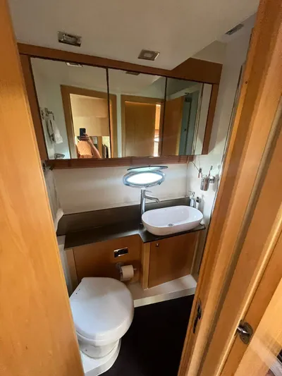  Yacht Photos Pics 2011 Sunseeker Portofino 48 yacht bathroom with modern fixtures and wooden cabinetry.