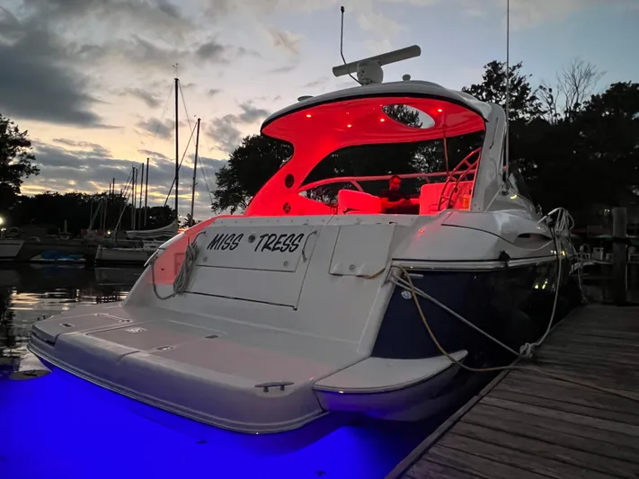  Yacht Photos Pics 2006 Cruisers Yachts 420 Express with red and blue lights docked at sunset.
