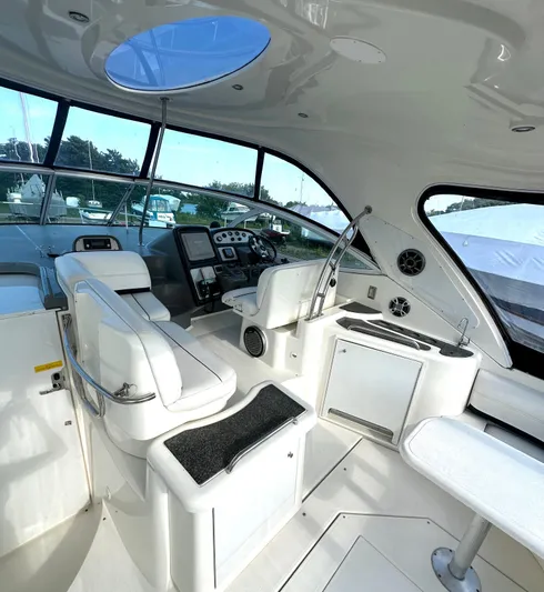  Yacht Photos Pics Interior of 2006 Cruisers Yachts 420 Express, featuring sleek white seating and modern controls.