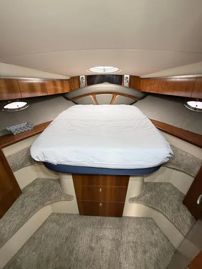  Yacht Photos Pics 2006 Cruisers Yachts 420 Express cabin with bed, wood accents, and portholes.