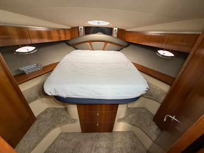  Yacht Photos Pics 2006 Cruisers Yachts 420 Express cabin interior with bed and wooden cabinetry.