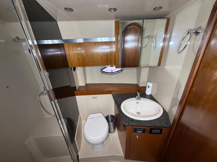  Yacht Photos Pics Luxurious 2006 Cruisers Yachts 420 Express bathroom with modern fixtures and wood accents.