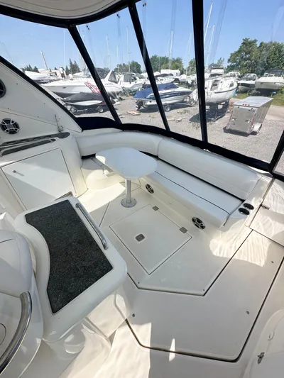  Yacht Photos Pics 2006 Cruisers Yachts 420 Express interior with seating and table, docked with boats visible outside.