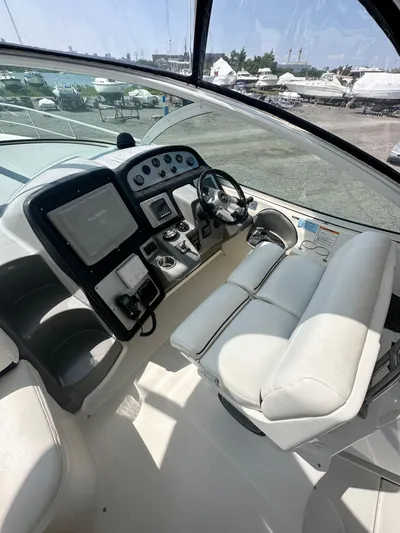  Yacht Photos Pics 2006 Cruisers Yachts 420 Express helm with modern controls and white seating.