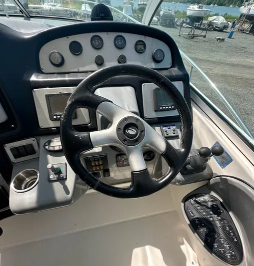  Yacht Photos Pics 2006 Cruisers Yachts 420 Express helm with steering wheel and control panel.