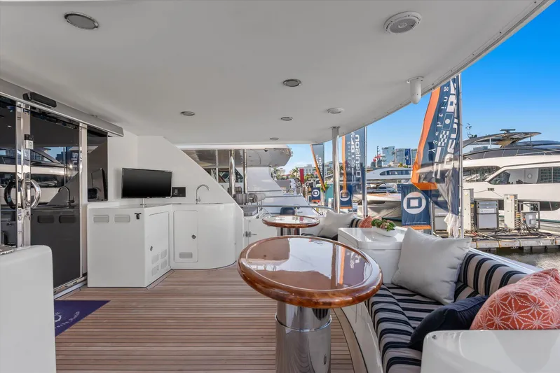 Miss Patti Yacht Photos Pics Luxurious 2008 Ocean Alexander 74 Motoryacht deck with seating and tables, docked at marina.