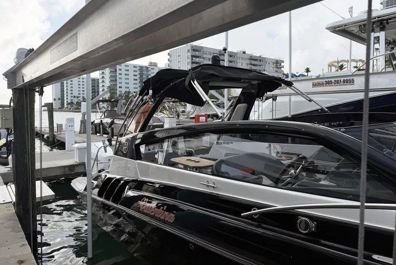  Yacht Photos Pics 2024 Hanover 305 boat docked at marina with cityscape background.