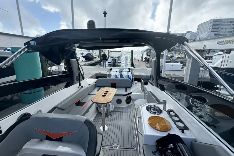  Yacht Photos Pics 2024 Hanover 305 boat interior with seating, table, and marina view.