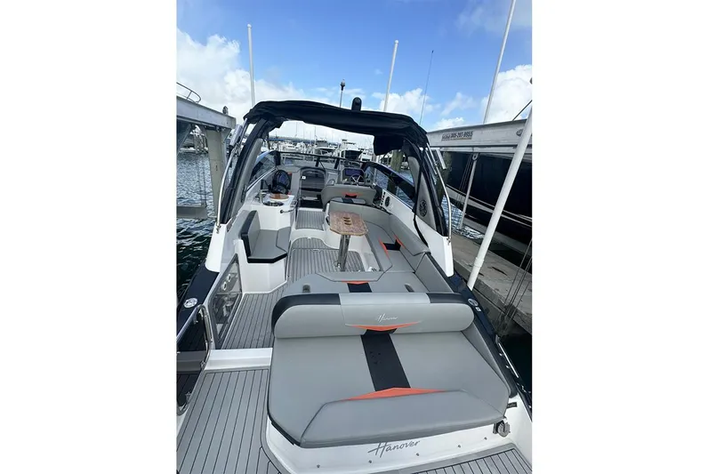  Yacht Photos Pics 2024 Hanover 305 boat with sleek interior design, docked at a marina.