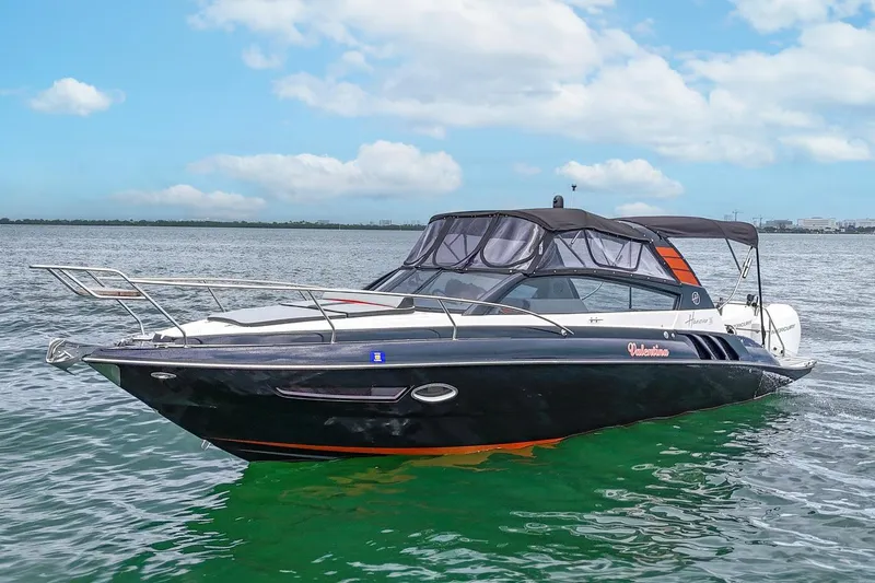  Yacht Photos Pics 2024 Hanover 305 boat on water, sleek design, black exterior, clear sky background.