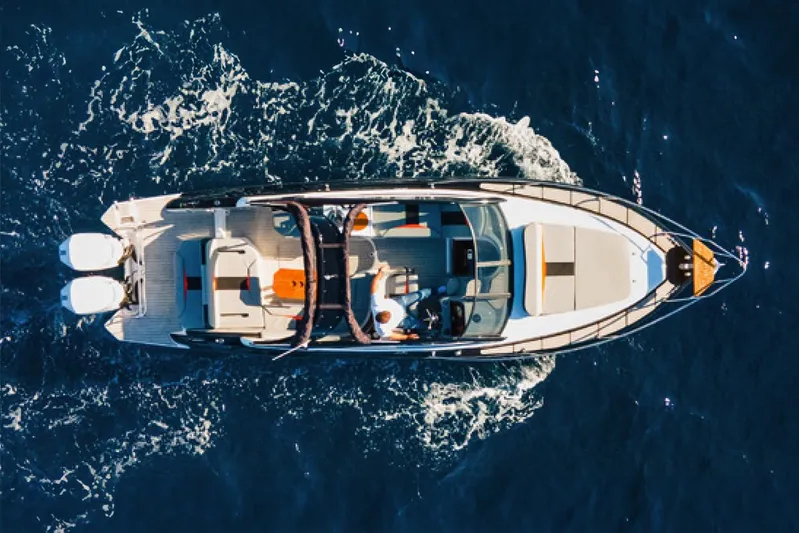  Yacht Photos Pics Aerial view of 2024 Hanover 305 boat cruising on open water.