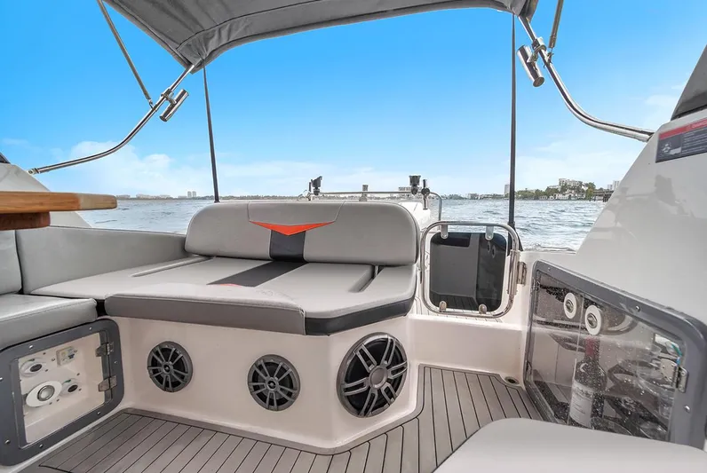  Yacht Photos Pics 2024 Hanover 305 boat interior with seating, speakers, and water view.