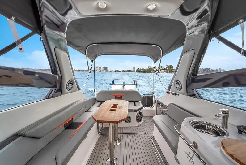  Yacht Photos Pics Luxurious 2024 Hanover 305 boat interior with seating, table, and water view.
