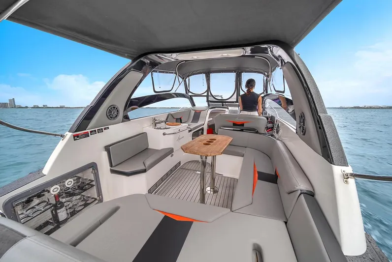  Yacht Photos Pics 2024 Hanover 305 boat interior with seating, table, and ocean view.