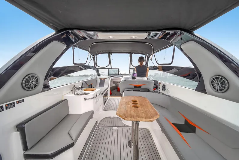  Yacht Photos Pics Luxurious 2024 Hanover 305 boat interior with modern seating and wooden table.