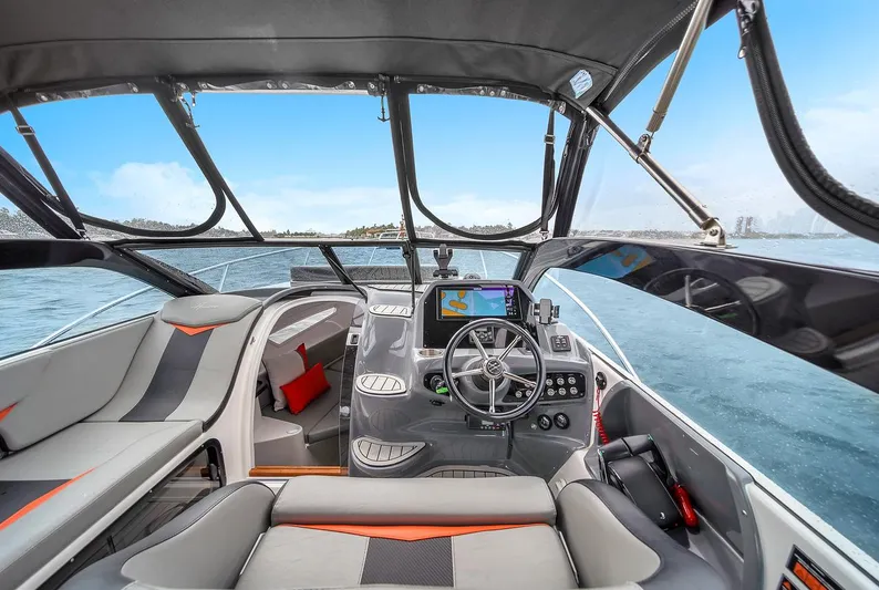  Yacht Photos Pics 2024 Hanover 305 boat interior with modern dashboard and seating on open water.