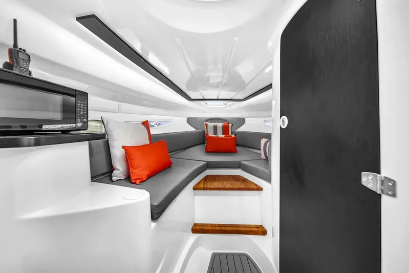  Yacht Photos Pics Luxurious interior of 2024 Hanover 305 boat with modern seating and vibrant cushions.