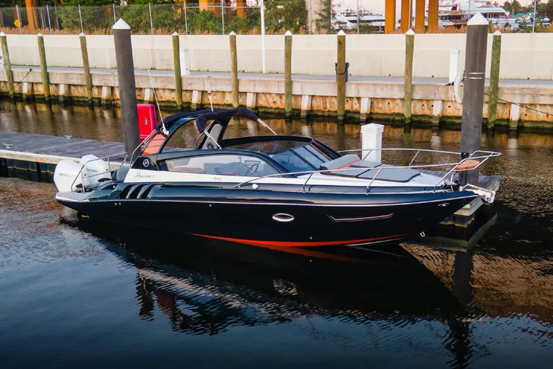  Yacht Photos Pics 2024 Hanover 305 boat docked in marina, sleek design, black and orange accents.