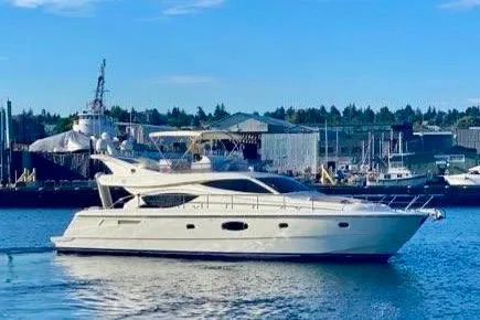 Mi Amore Yacht Photos Pics 2006 Ferretti Yachts 550 cruising in a harbor with industrial backdrop.