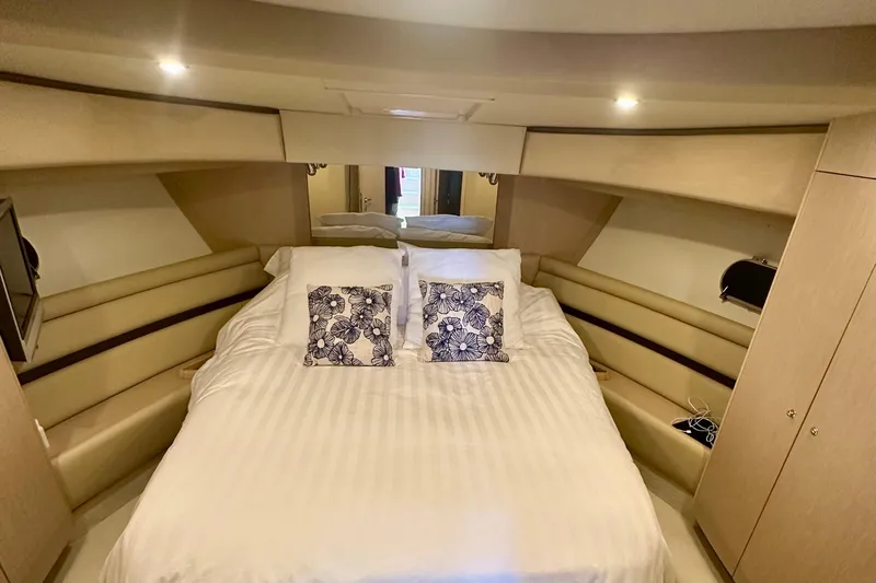 Mi Amore Yacht Photos Pics Luxurious bedroom interior of 2006 Ferretti Yachts 550 with elegant bedding and ambient lighting.