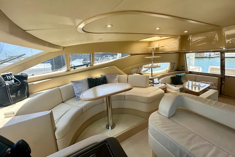 Mi Amore Yacht Photos Pics Luxurious interior of a 2006 Ferretti Yachts 550 with elegant seating and panoramic windows.