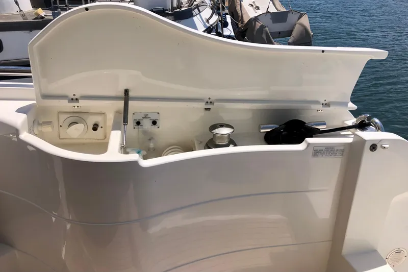 Mi Amore Yacht Photos Pics 2006 Ferretti Yachts 550 yacht deck with open storage compartment, docked by the water.