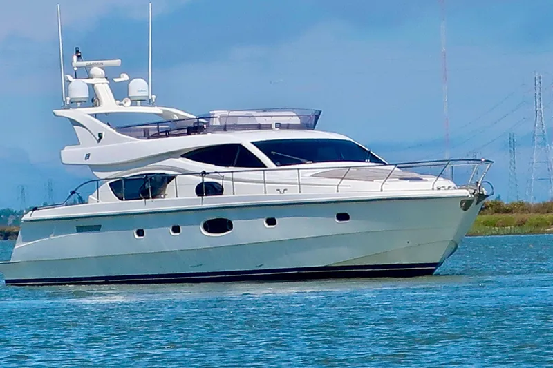 Mi Amore Yacht Photos Pics 2006 Ferretti Yachts 550 cruising on calm waters under a clear blue sky.
