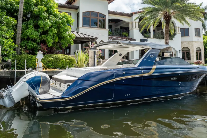  Yacht Photos Pics 2019 Sea Ray SLX 400 Outboard boat docked by a luxurious waterfront home.