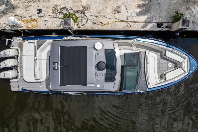  Yacht Photos Pics Overhead view of 2019 Sea Ray SLX 400 Outboard docked, showcasing spacious seating and triple engines.