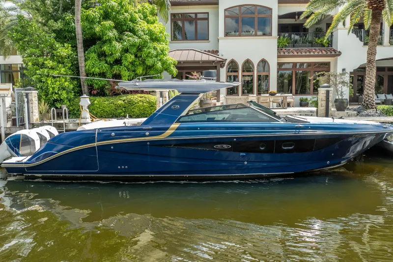  Yacht Photos Pics 2019 Sea Ray SLX 400 Outboard boat docked by a luxurious waterfront home.