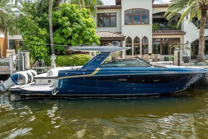  Yacht Photos Pics 2019 Sea Ray SLX 400 Outboard boat docked by a luxurious waterfront home.