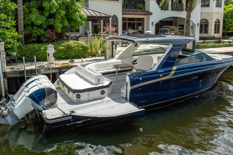  Yacht Photos Pics 2019 Sea Ray SLX 400 Outboard luxury boat docked by waterfront home.
