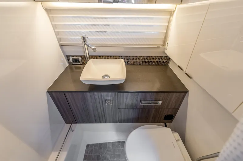  Yacht Photos Pics Luxurious bathroom in 2019 Sea Ray SLX 400 Outboard with modern sink and toilet.