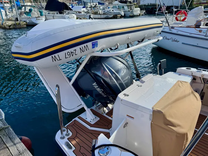  Yacht Photos Pics 2024 Ranger Tugs R-27 with Yamaha outboard motor and dinghy, docked at marina.