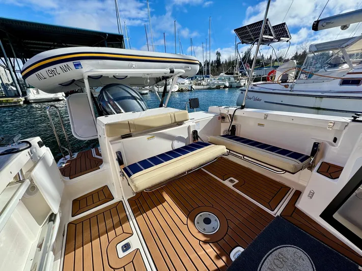  Yacht Photos Pics 2024 Ranger Tugs R-27 boat interior with seating, docked at marina.