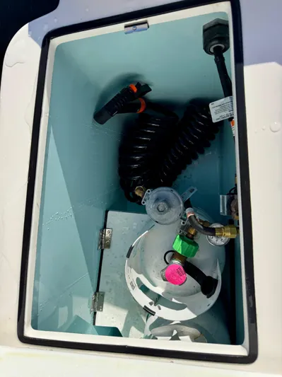  Yacht Photos Pics 2024 Ranger Tugs R-27 storage compartment with coiled hose and fittings.