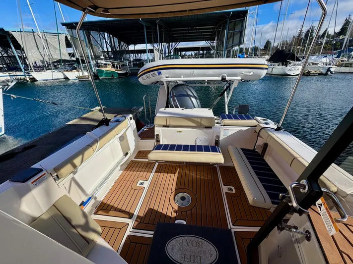  Yacht Photos Pics 2024 Ranger Tugs R-27 boat interior with teak flooring at a marina.
