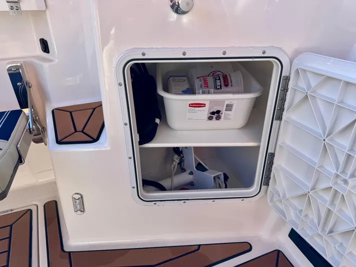  Yacht Photos Pics 2024 Ranger Tugs R-27 storage compartment with organized supplies and accessories.