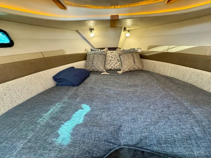  Yacht Photos Pics Cozy interior cabin of 2024 Ranger Tugs R-27 with comfortable bedding and ambient lighting.