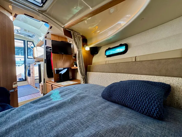  Yacht Photos Pics 2024 Ranger Tugs R-27 cabin interior with bed, TV, and window.