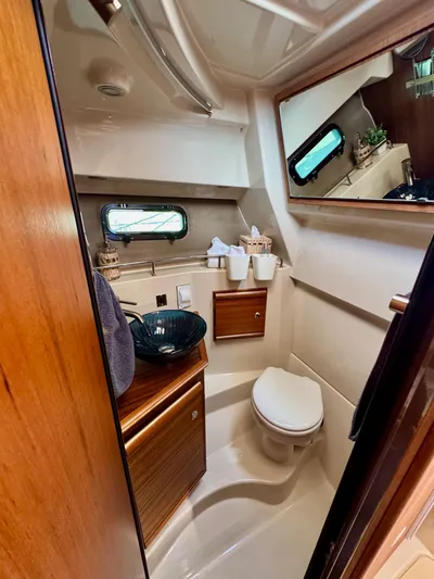  Yacht Photos Pics 2024 Ranger Tugs R-27 bathroom with modern fixtures, wooden cabinetry, and a sleek design.