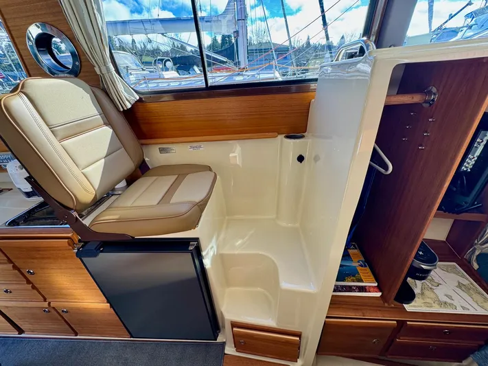  Yacht Photos Pics 2024 Ranger Tugs R-27 interior with seating, fridge, and storage.