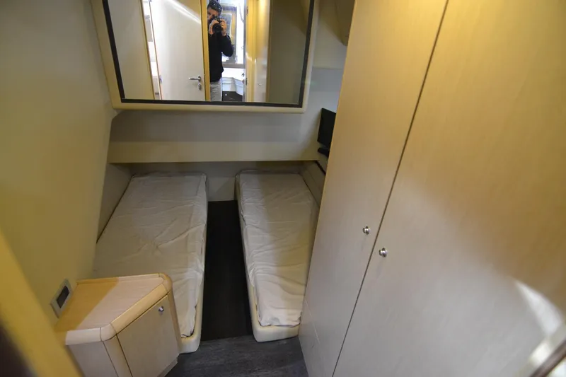  Yacht Photos Pics Interior cabin of 2006 Ferretti Yachts 550 with twin beds and modern furnishings.