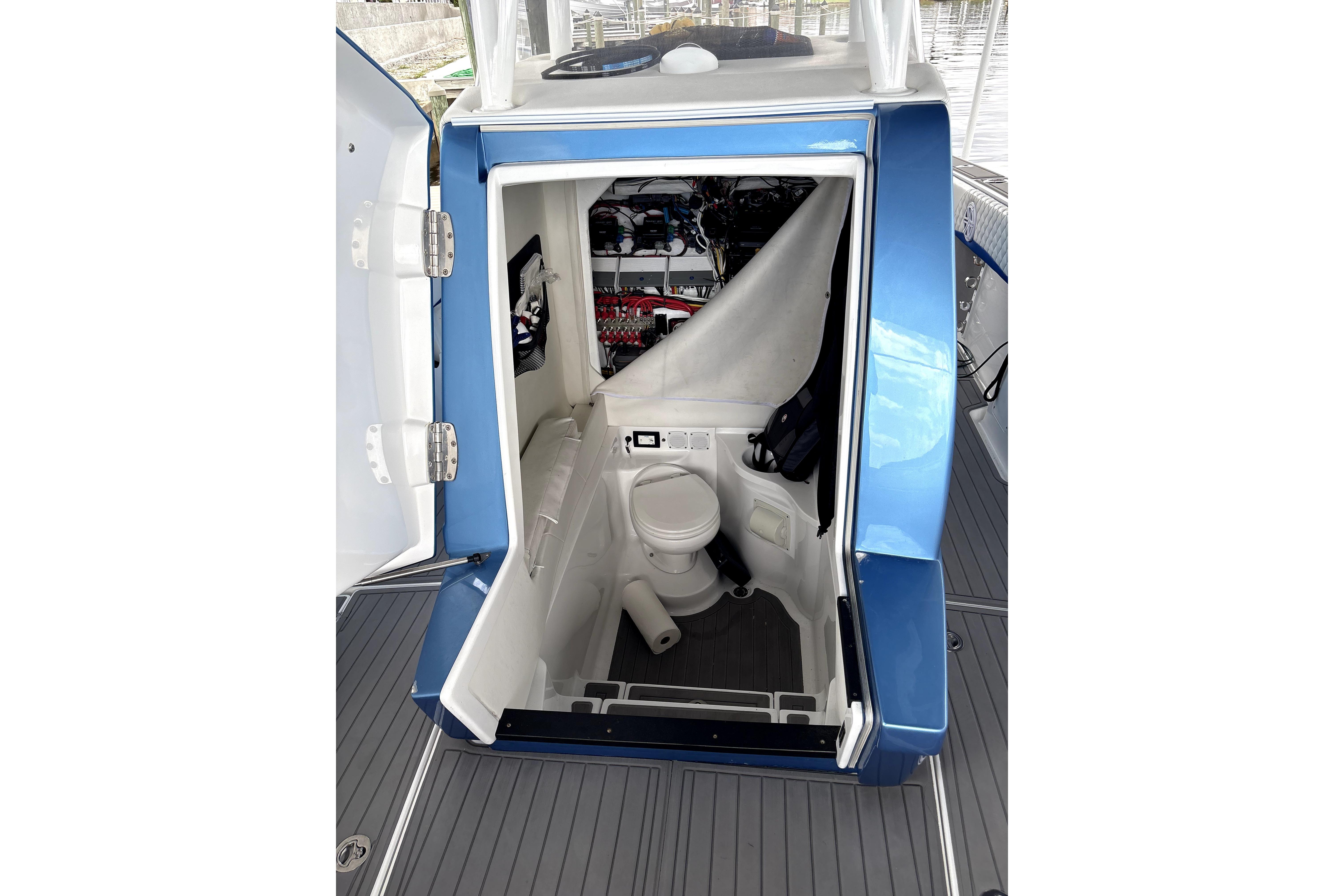2019 Statement Fishing Edition boat interior with open door revealing compact marine toilet.